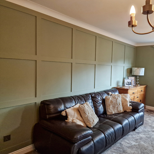 Green Square Panelling Behind Sofa In Living Room